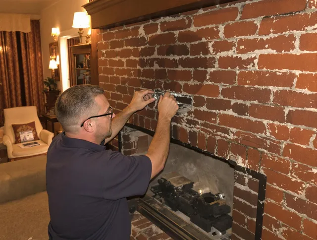 Whitehall Chimney Sweep expert fixing a fireplace in Whitehall, OH